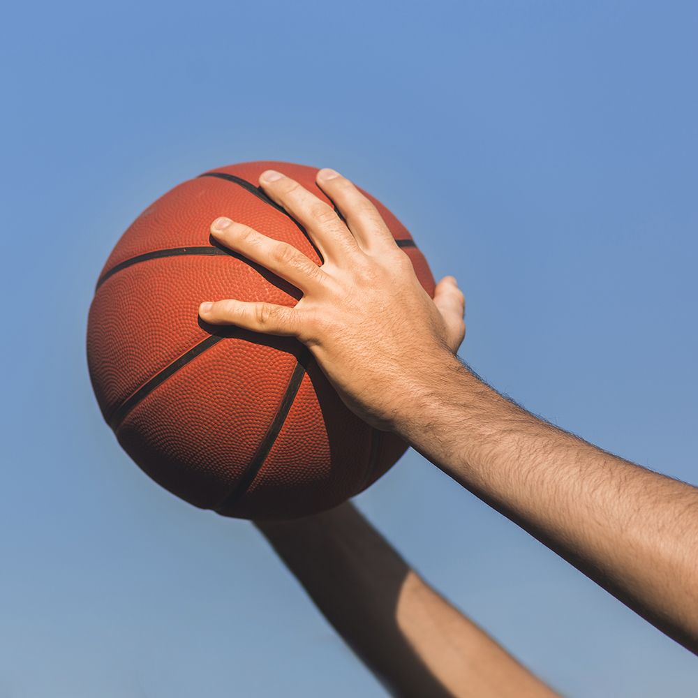 hands-holding-basketball-side-view